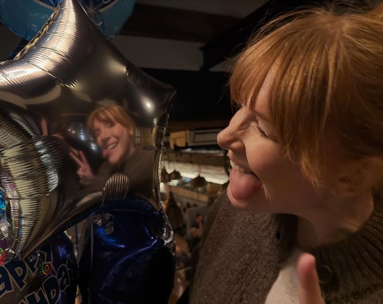 Another year around the sun! 😜 Thank you all for the birthday wishes! Feeling grateful ❤️🎈❤️[ID: Shown in the reflection of a silver star-shaped ballon, BDH makes a silly face, winking with her tongue out] by @brycedhoward